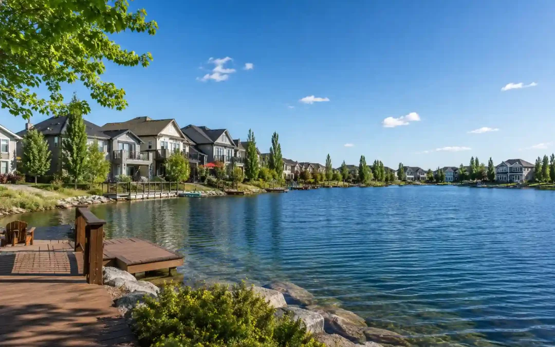 Waterfront homes along a calm lake with private docks and walking paths on a sunny day.